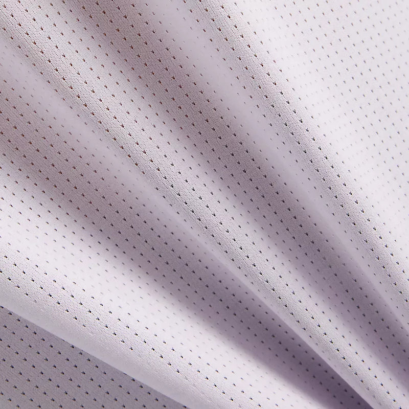 chandail à manches longues NB ICEx gris, avec tissu respirant et trous pour les pouces, idéal pour le sport.